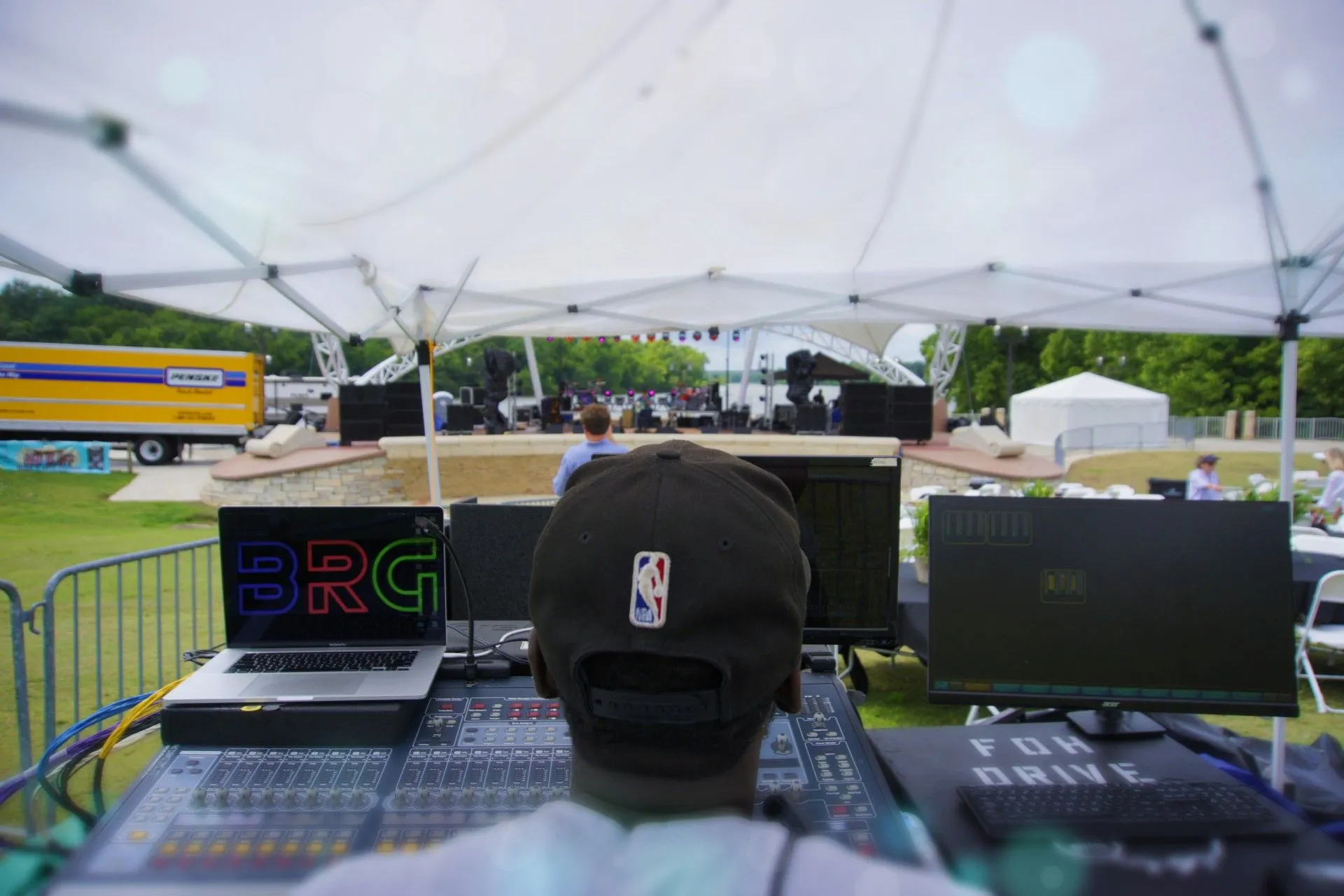 Hands adjusting a live event audio console
